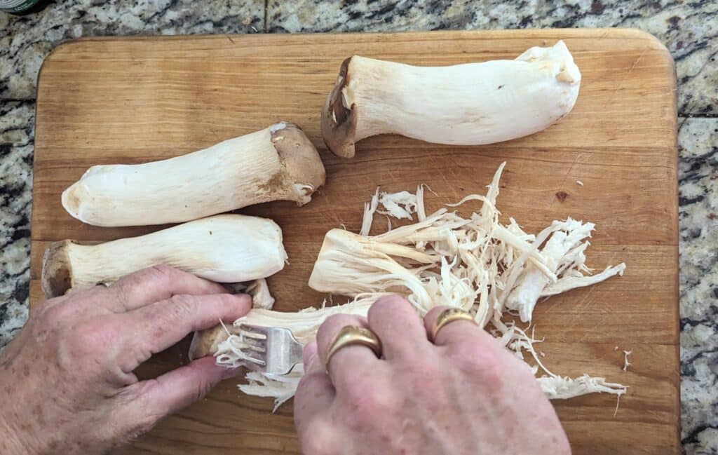 shredding king oyster mushrooms